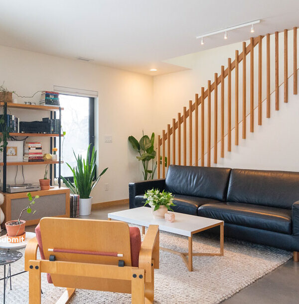 A living room with furniture and plants in it