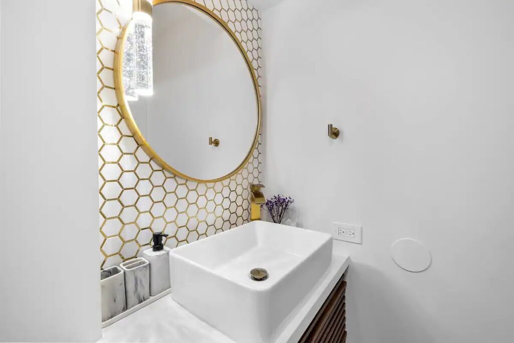 A bathroom with a sink and mirror in it