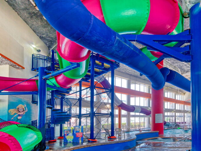 A large indoor water park with many slides.