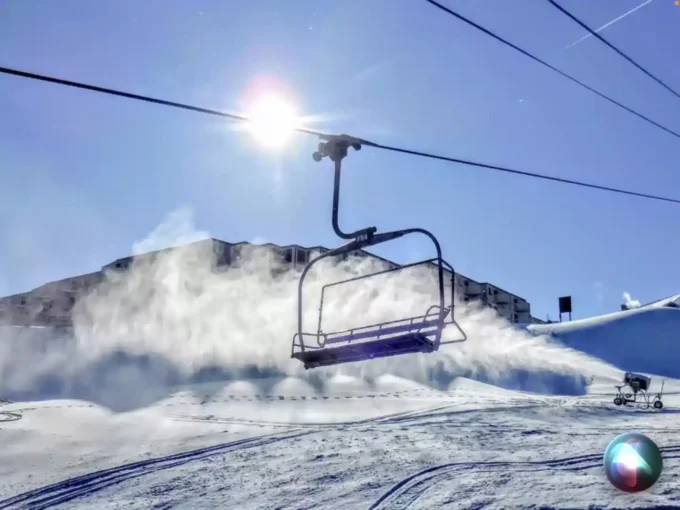 A ski lift is flying through the air.