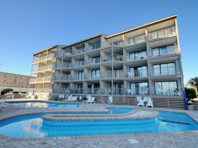 A large building with many windows and a pool