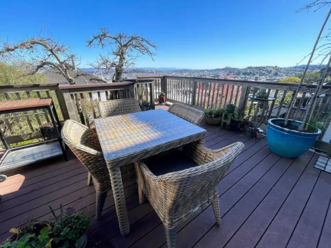 A table and chairs on top of a deck.