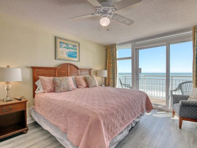 A bedroom with a bed and a balcony